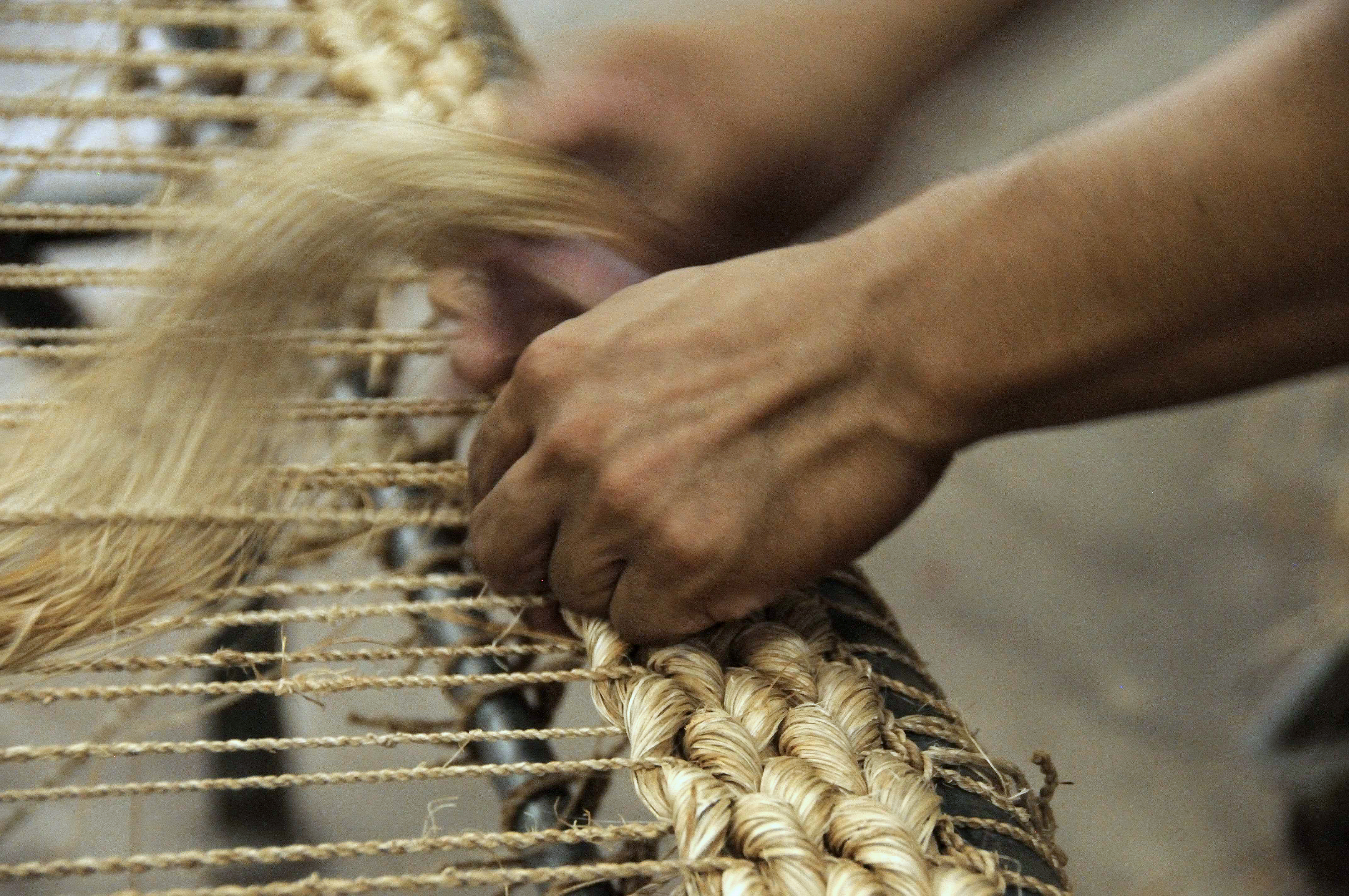 Abaca rug being hand braided